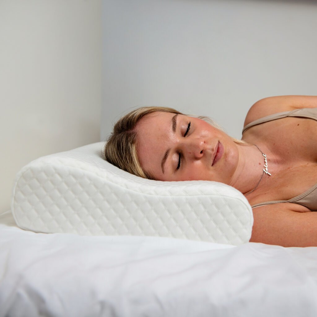 Woman sleeping on Sleeporium memory foam neck pillow