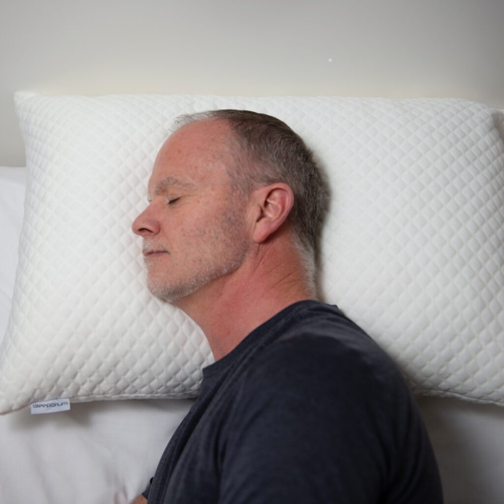 Man using Sleeporium CustomCloud adjustable pillow